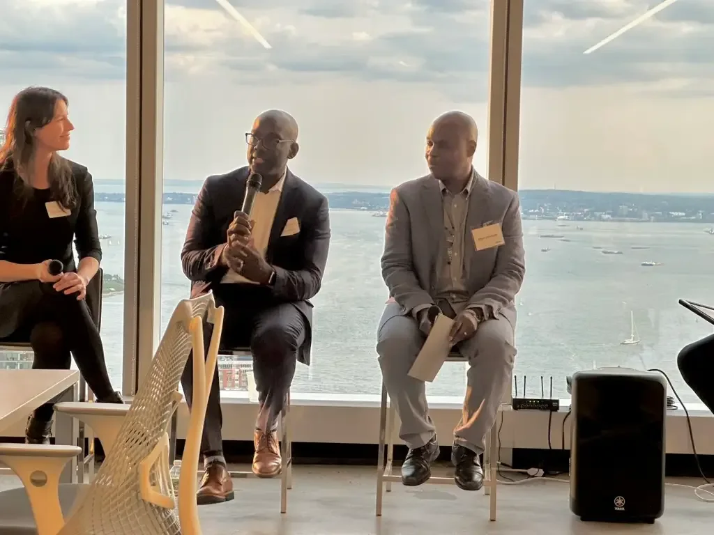 Rashan Thompson speaking on stage at panel event